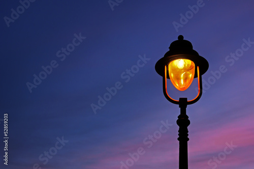 lamppost illuminated at twilight photo