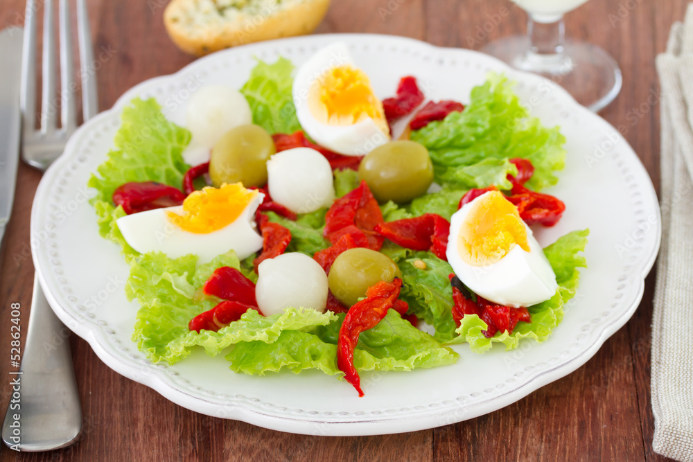 salad with egg and olive on the white plate salad with egg and olive on the white plate