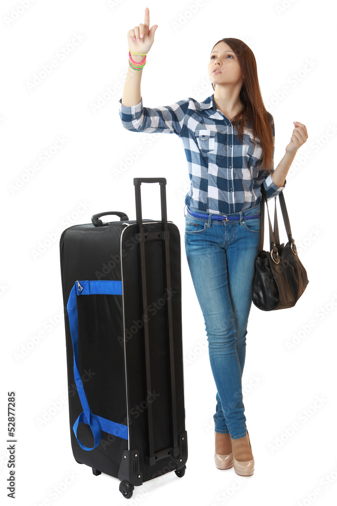 A young girl with a big, black travel bag on wheels, looks timet A young girl with a big, black travel bag on wheels, looks timet
