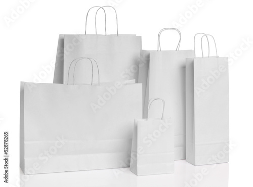 Various white paper shopping bags isolated