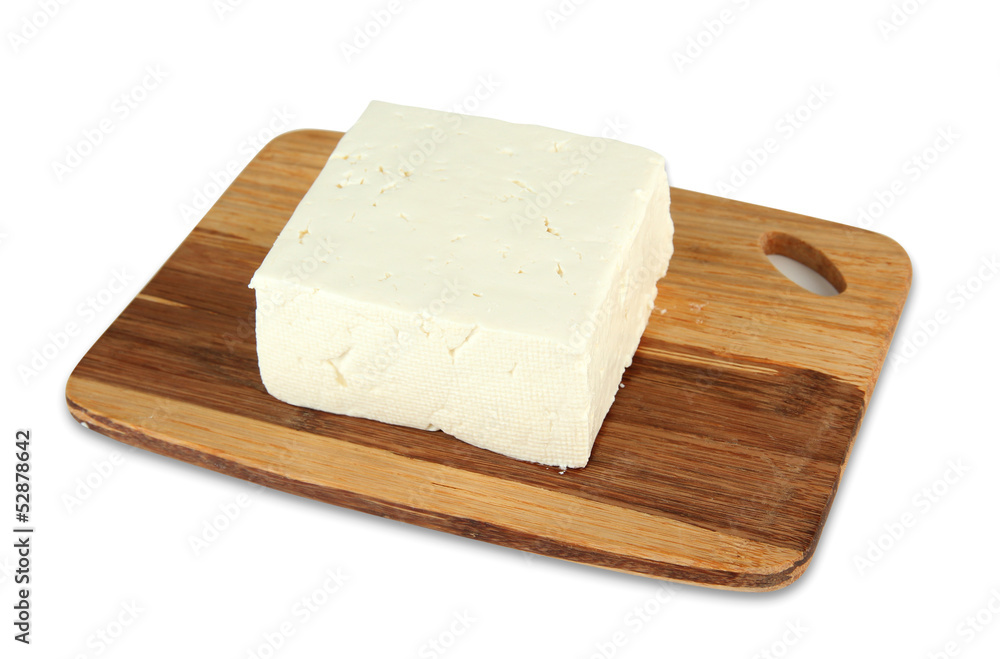 Sheep milk cheese on cutting board, isolated on white