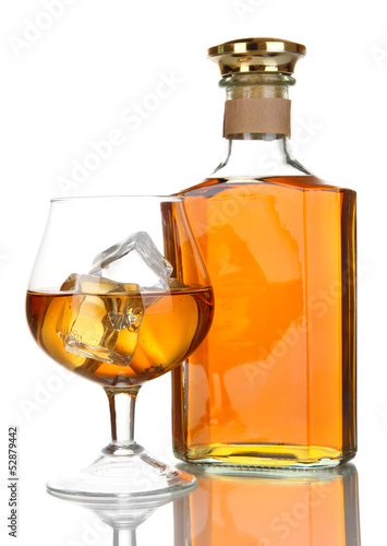 Glass of brandy and bottle isolated on white