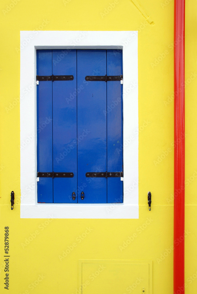 Blue window on yellow wall Blue window on yellow wall