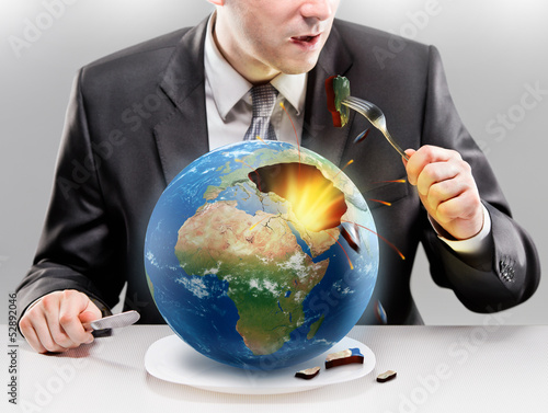 Obraz na plátně Greedy businessman eating planet Earth