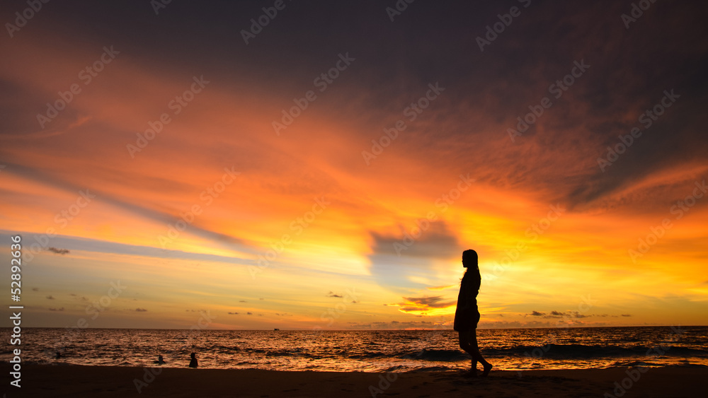 silhouette of single young woman on beach when sunset