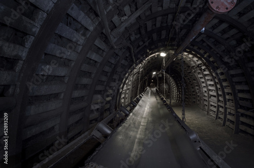 Coal mine machinery: belt conveyor in underground tunnel © eunikas