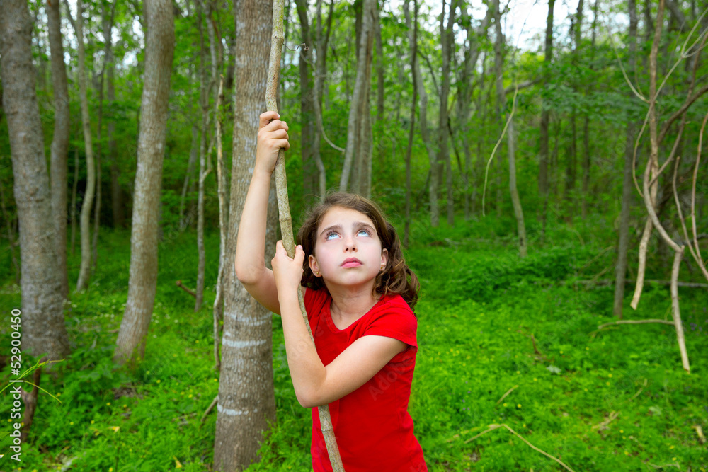 Happy girl playing in forest park jungle with liana Happy girl playing in forest park jungle with liana