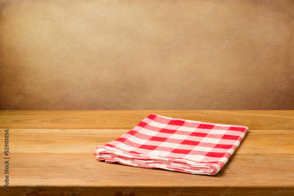 Empty wooden table with tablecloth over grunge background Empty wooden table with tablecloth over grunge background