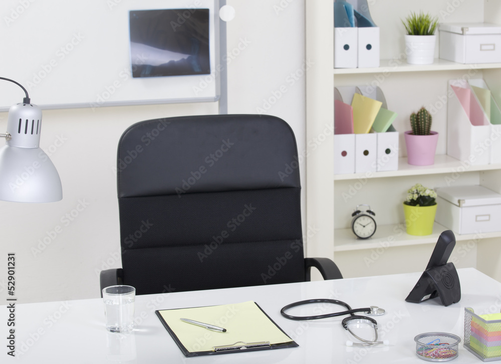 Doctor office table desk and black chair with stethoscope  and w