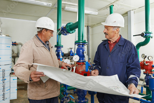 heating engineer repairman in boiler room