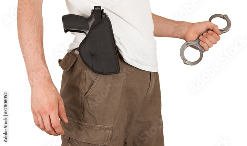 Fotografering Close-up of a man with a gun and handcuffs