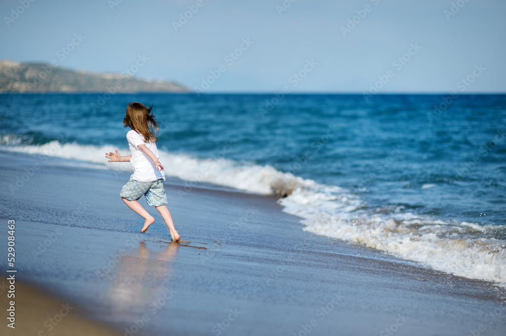 Adorable little girl on a sandy beach