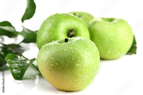 Juicy green apples with leaves, isolated on white