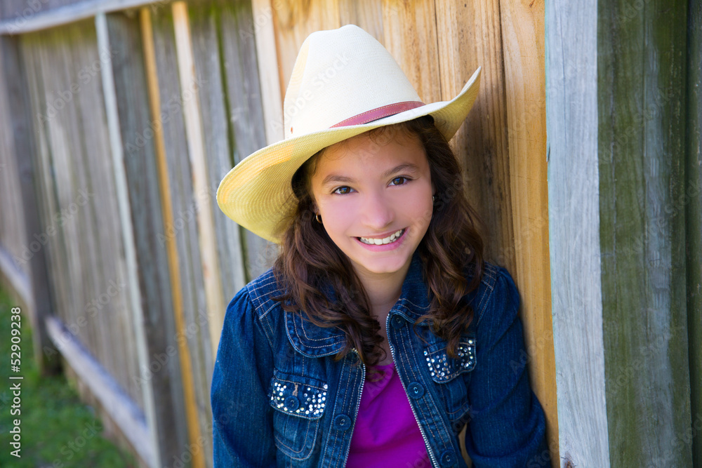 Little kid girl pretending to be a cowboy with hat