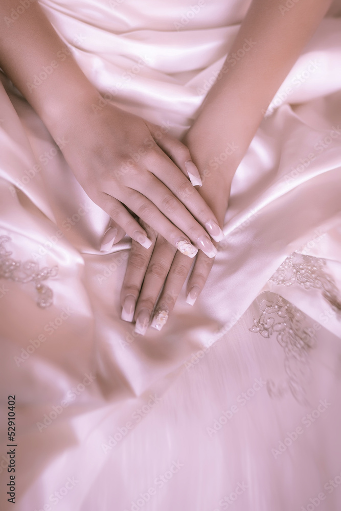 bride's hands on a white wedding dress bride's hands on a white wedding dress