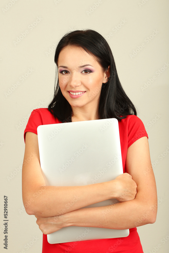 Beautiful young woman with notebook in room Beautiful young woman with notebook in room