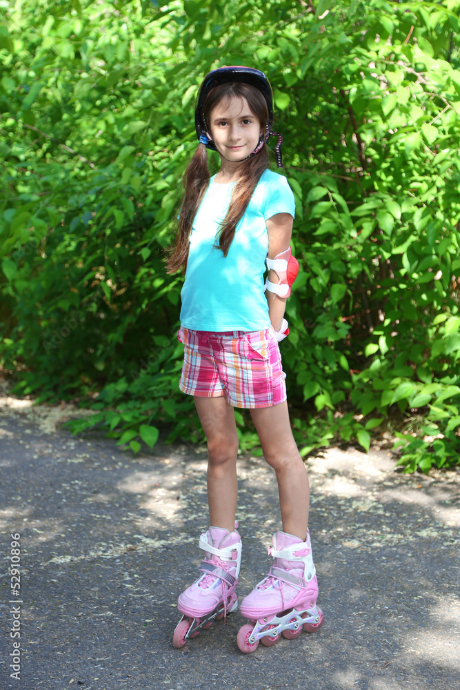 Little girl in roller skates at  park