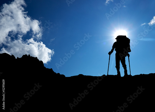 Silhouette of a tourist in the montains. Sport and active life