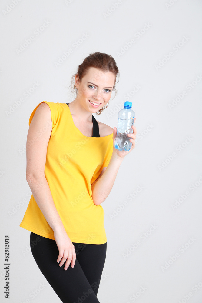 Beautiful young woman with bottle of water Beautiful young woman with bottle of water