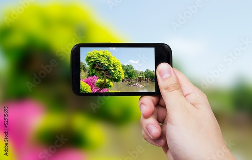 Smart phone with japanese garden view on display