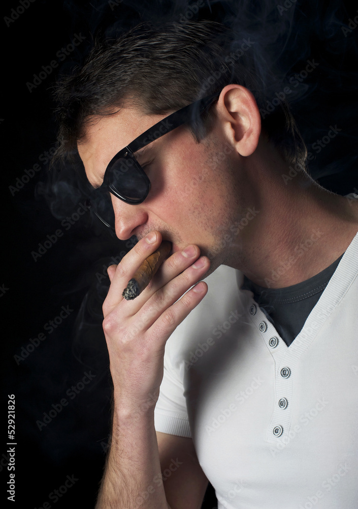 Fototapeta premium Portrait of a man smoking a cigar