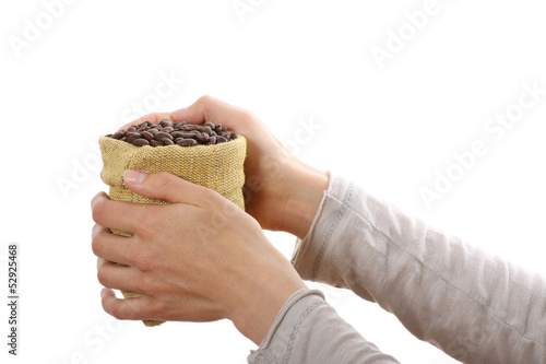 Small bag of coffee beans in female hands, isolated on white