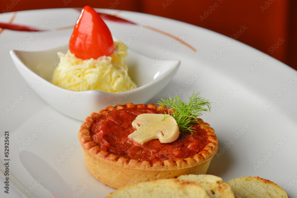 Tasty tartare pate (Raw beef) on white plate, served with butter Tasty tartare pate (Raw beef) on white plate, served with butter