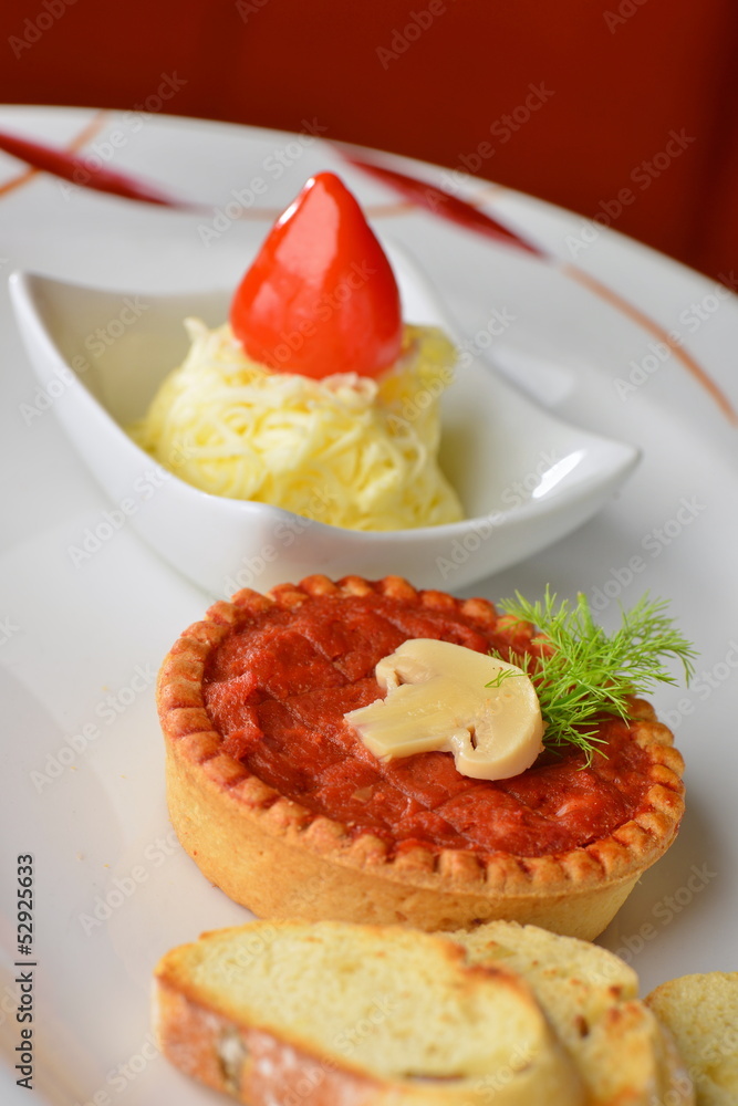 Tasty tartare pate (Raw beef) on white plate, served with butter