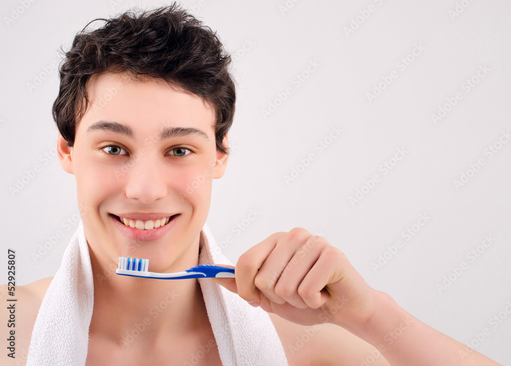 Man with beautiful teeth smiling and holding a toothbrush. Man with beautiful teeth smiling and holding a toothbrush.