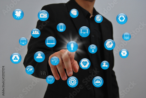 Businessman pressing virtual media type of buttons photo