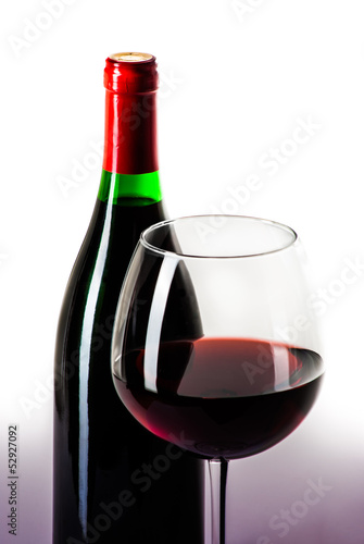 Wine bottle and a glass filled with wine isolated on white