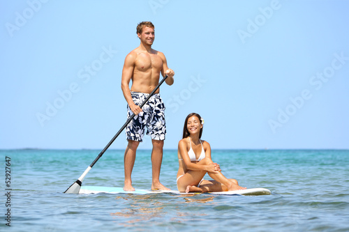 Canvas Print Beach fun couple on stand up paddleboard