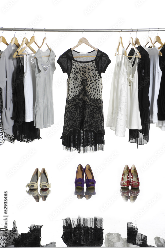casual fashion clothing hanging on hangers and boots casual fashion clothing hanging on hangers and boots
