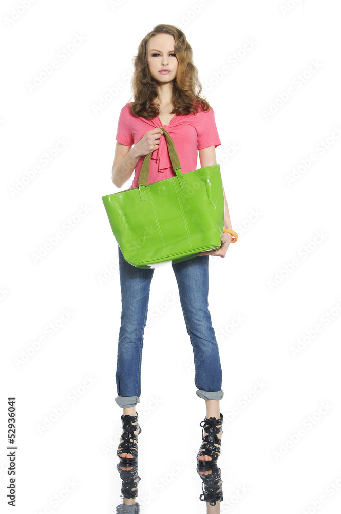 young woman in casual clothes with green bag posing young woman in casual clothes with green bag posing