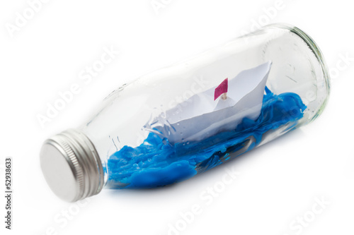 Dream concept. Handmade paper boat in a bottle
