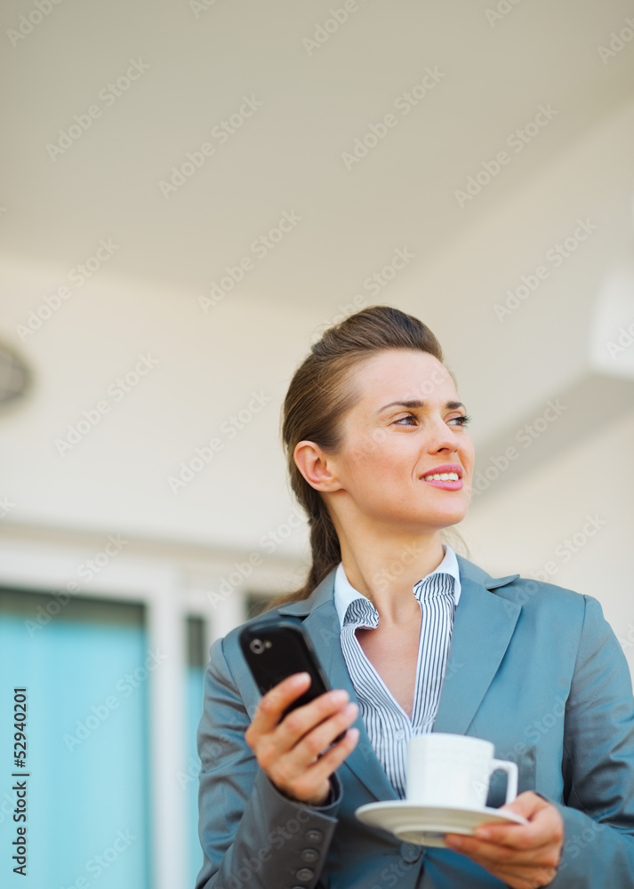 Thoughtful business woman with mobile phone on terrace Thoughtful business woman with mobile phone on terrace