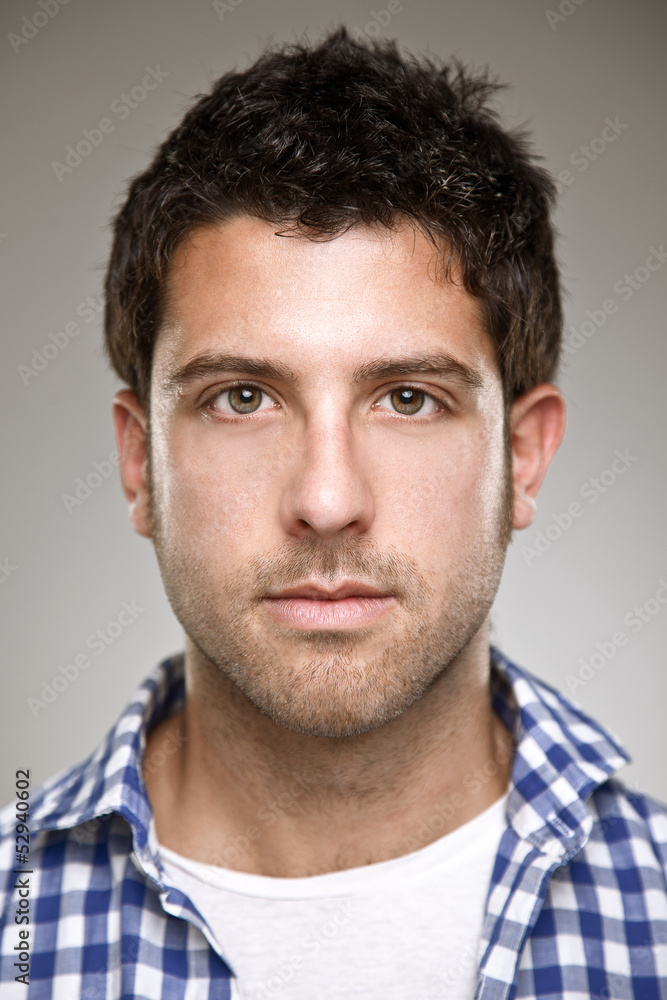 Portrait of a normal young man on a grey background Portrait of a normal young man on a grey background
