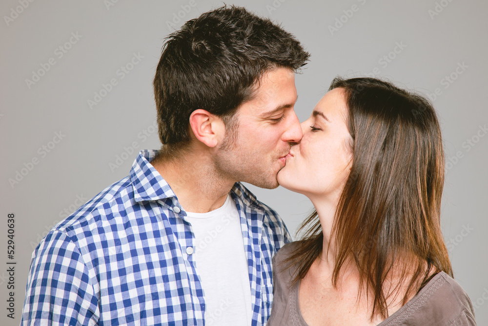 Portrait of a beautiful young couple kissing