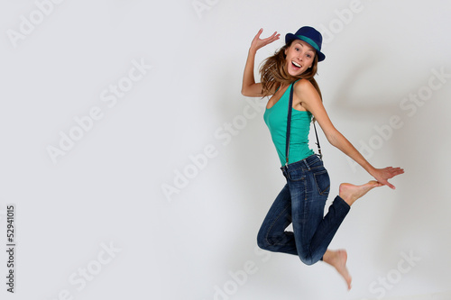 Funny brunette girl jumping up in the air