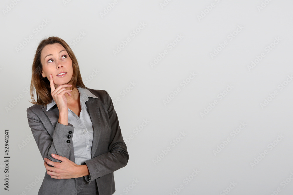 Businesswoman looking up at message Businesswoman looking up at message