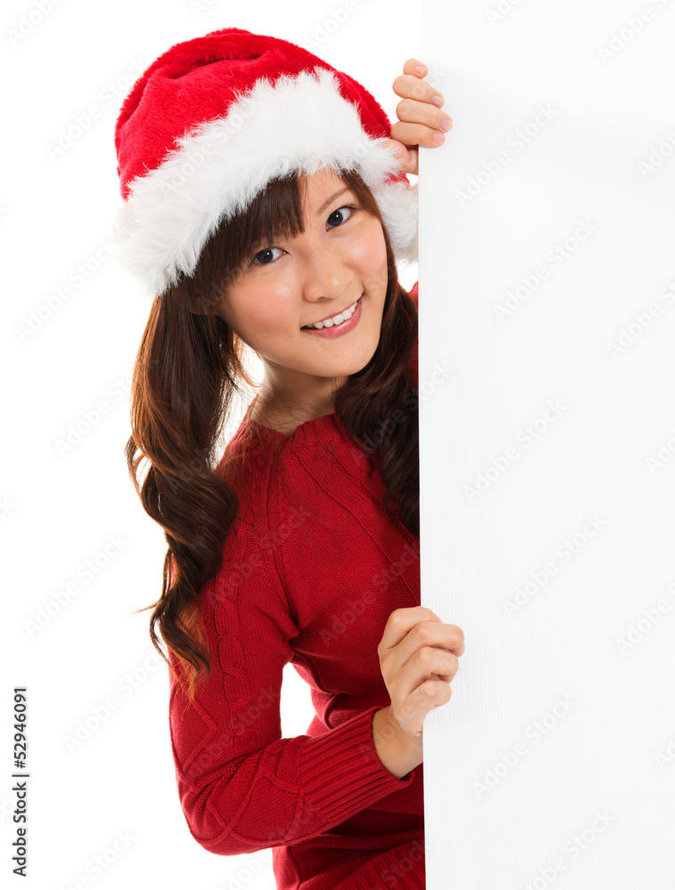 Christmas girl peeking from behind blank sign billboard. Christmas girl peeking from behind blank sign billboard.