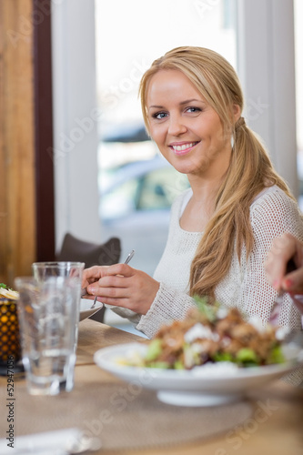 Young Woman Having Food At Coffeeshop