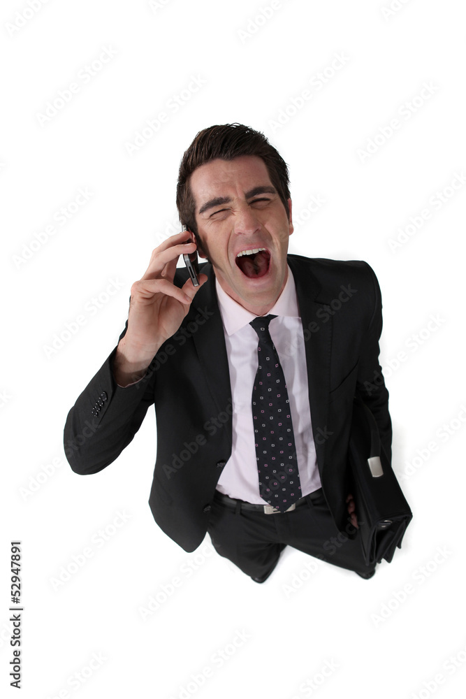 Businessman screaming down the telephone Businessman screaming down the telephone