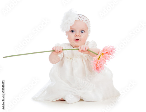 baby girl holding flower gi...