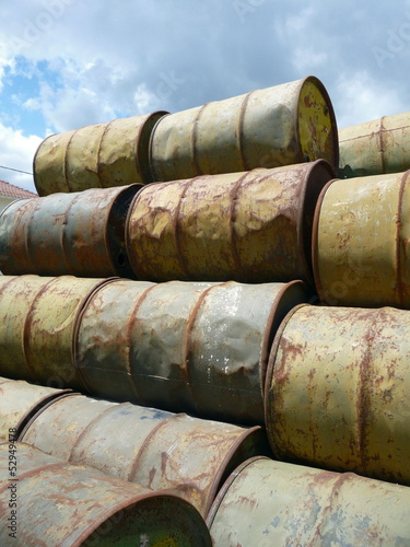 pile of stacked rusty steel oil barrels 