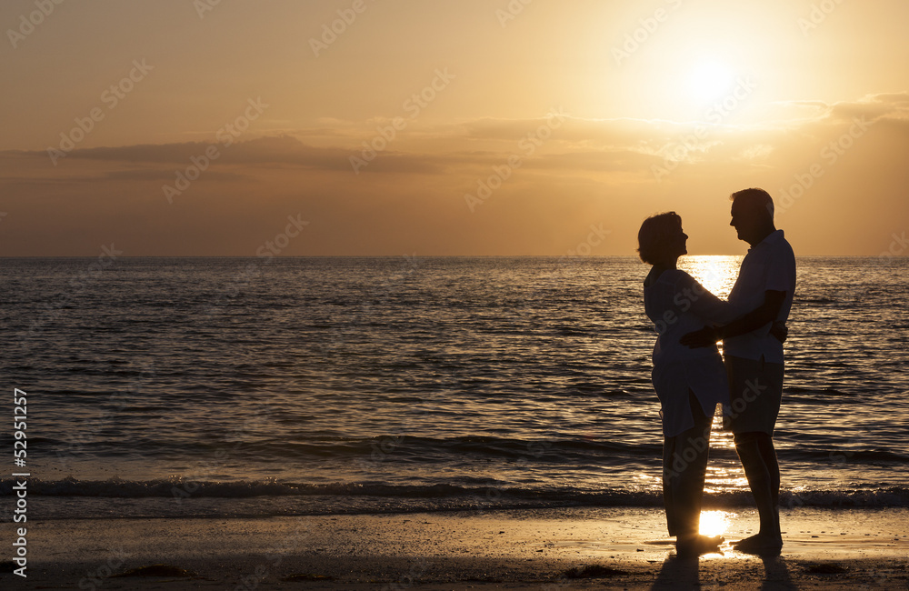 Fototapeta premium Happy Senior Couple Embracing on Sunset Beach