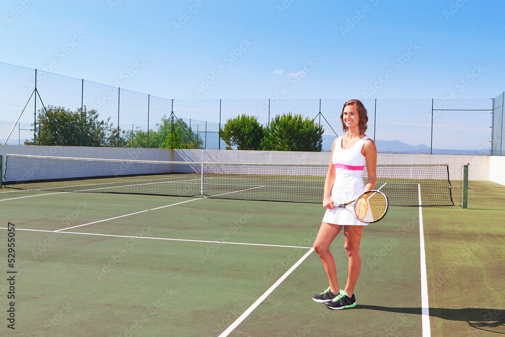Beautiful young girl with a tennis racket posing for the press.