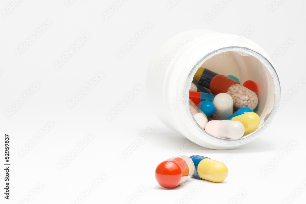 medical pills in laboratory near white container medical pills in laboratory near white container