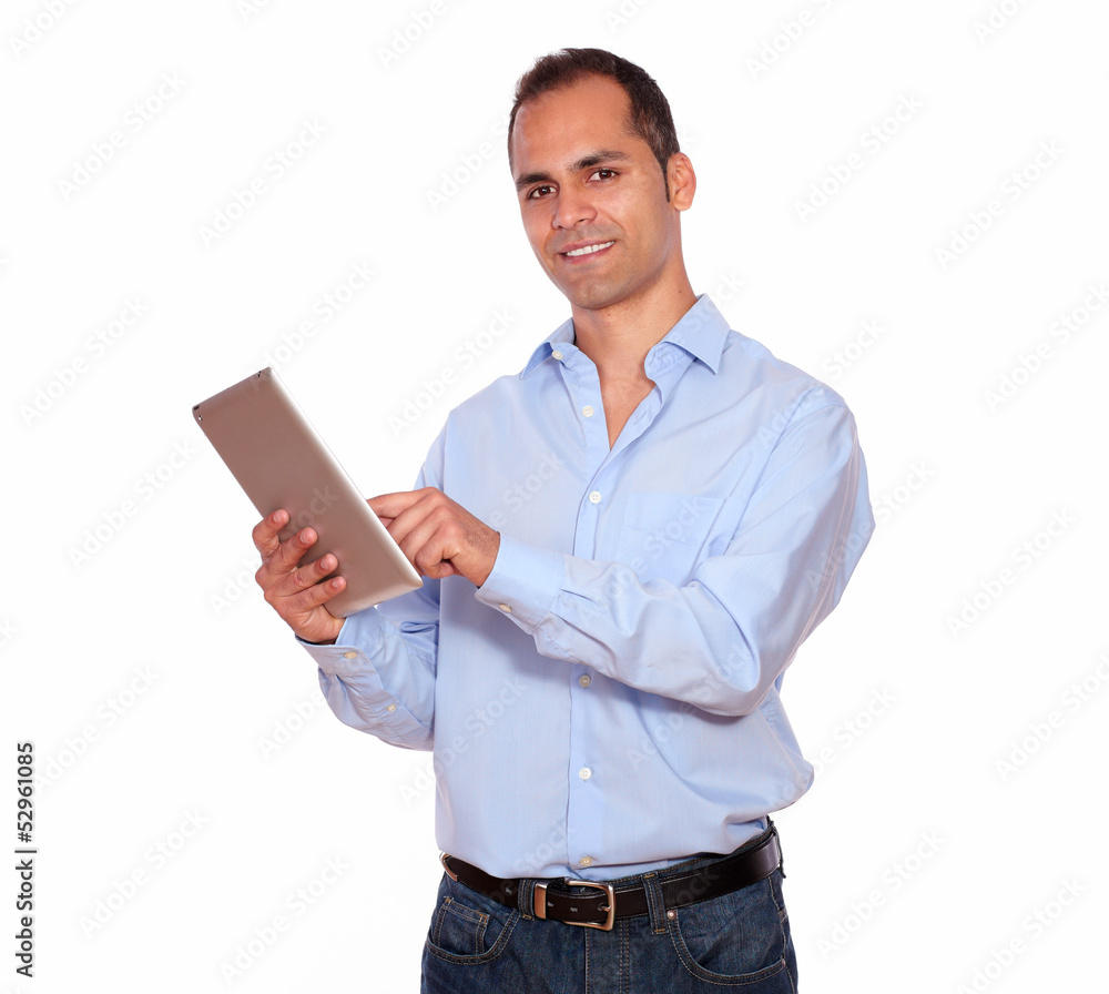 Hispanic adult man using his tablet pc Hispanic adult man using his tablet pc