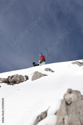 Snowboarder at the top of a mountain